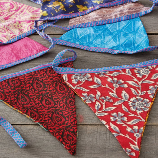 String of fabric recycled sari bunting. Assorted bright colours and designs.