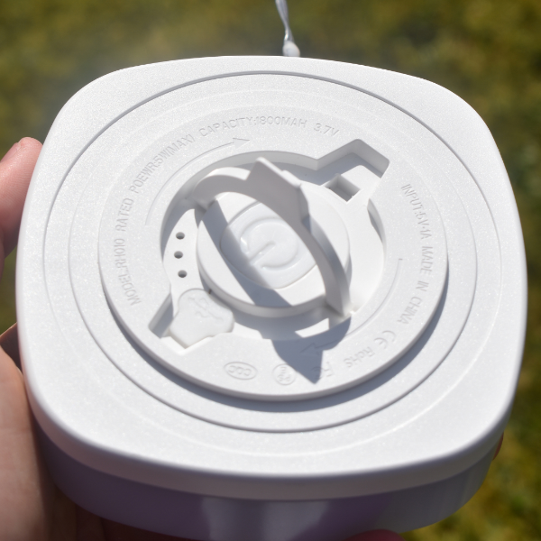 white underside of retractable string light and lantern with carry handle or winder