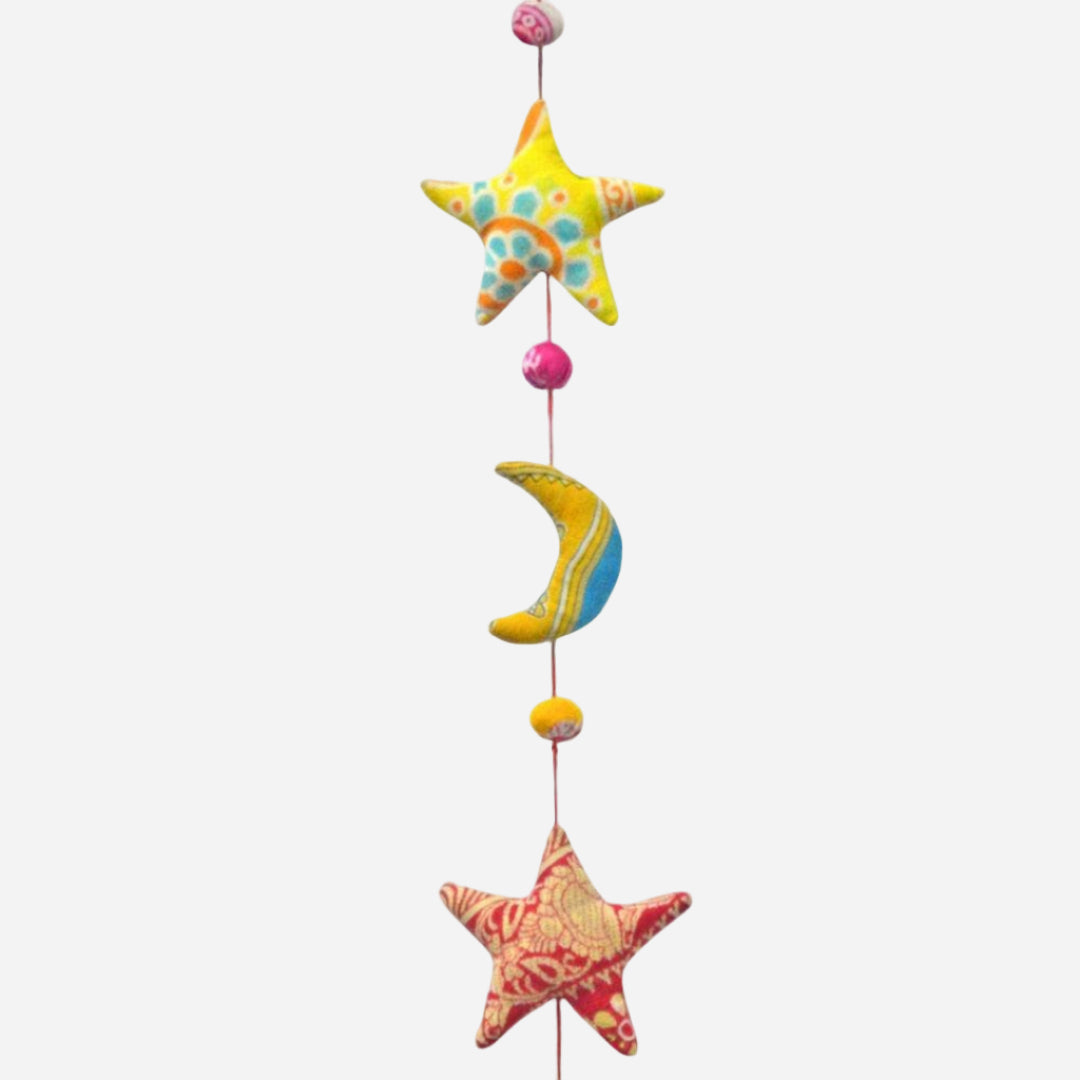 Decorative hanging mobile with stars and a moon on a white background