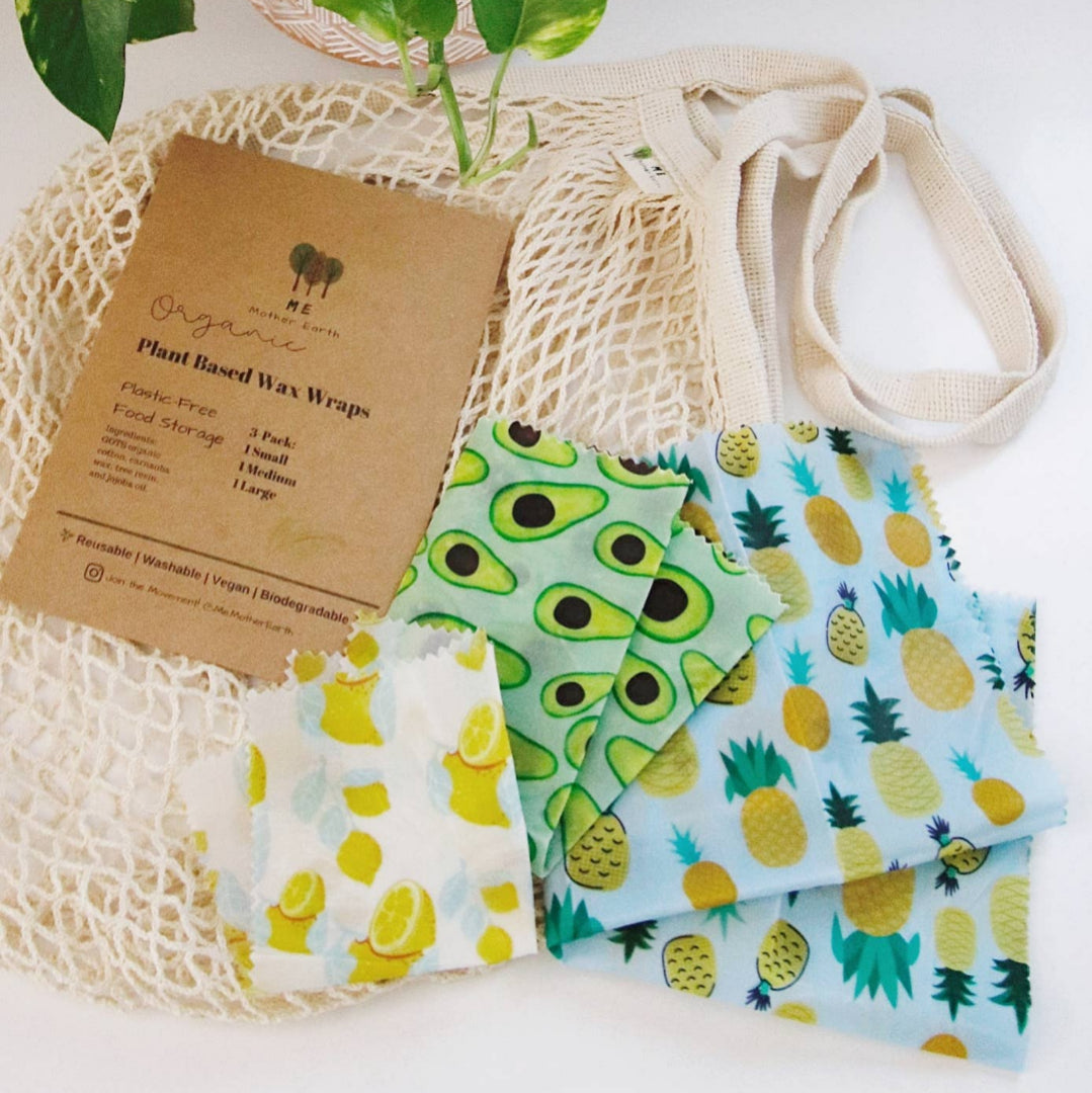 Three organic, plant-based, wax food wraps with avocado, lemon and pineapple print (small, medium, large). Cardboard outer packaging.
