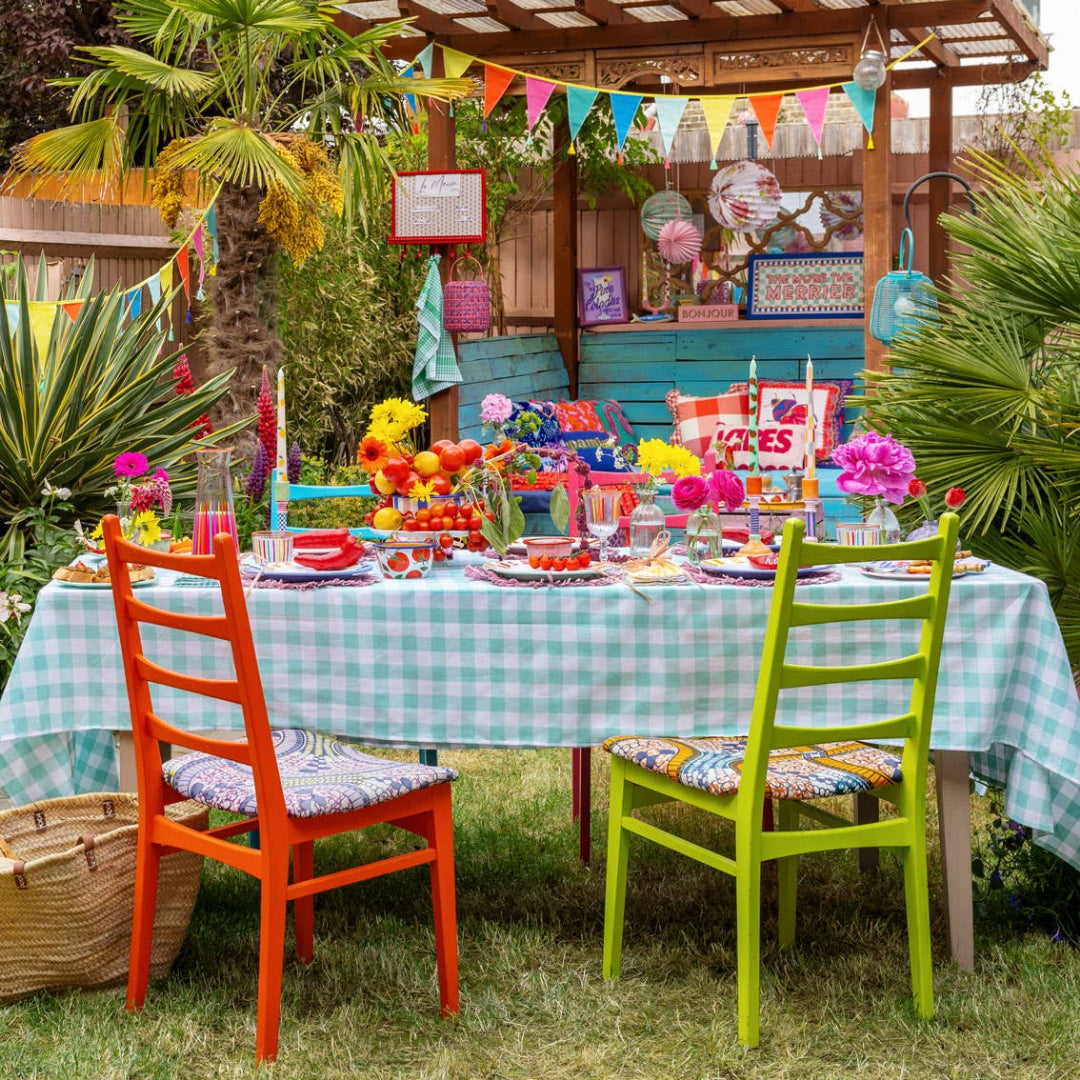 Garden party scene featuring the cotton rainbow bunting with tassles across the gazebo.