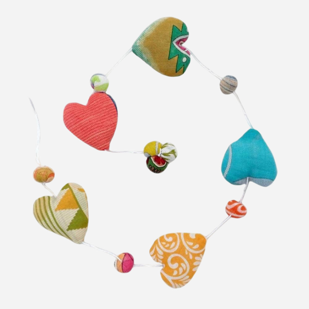 Colorful heart-shaped fabric decorative string on a white background