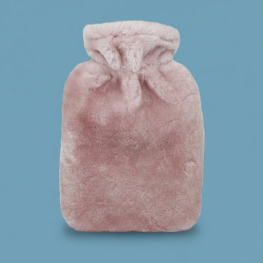 Pink sheepskin hot water bottle on a white background