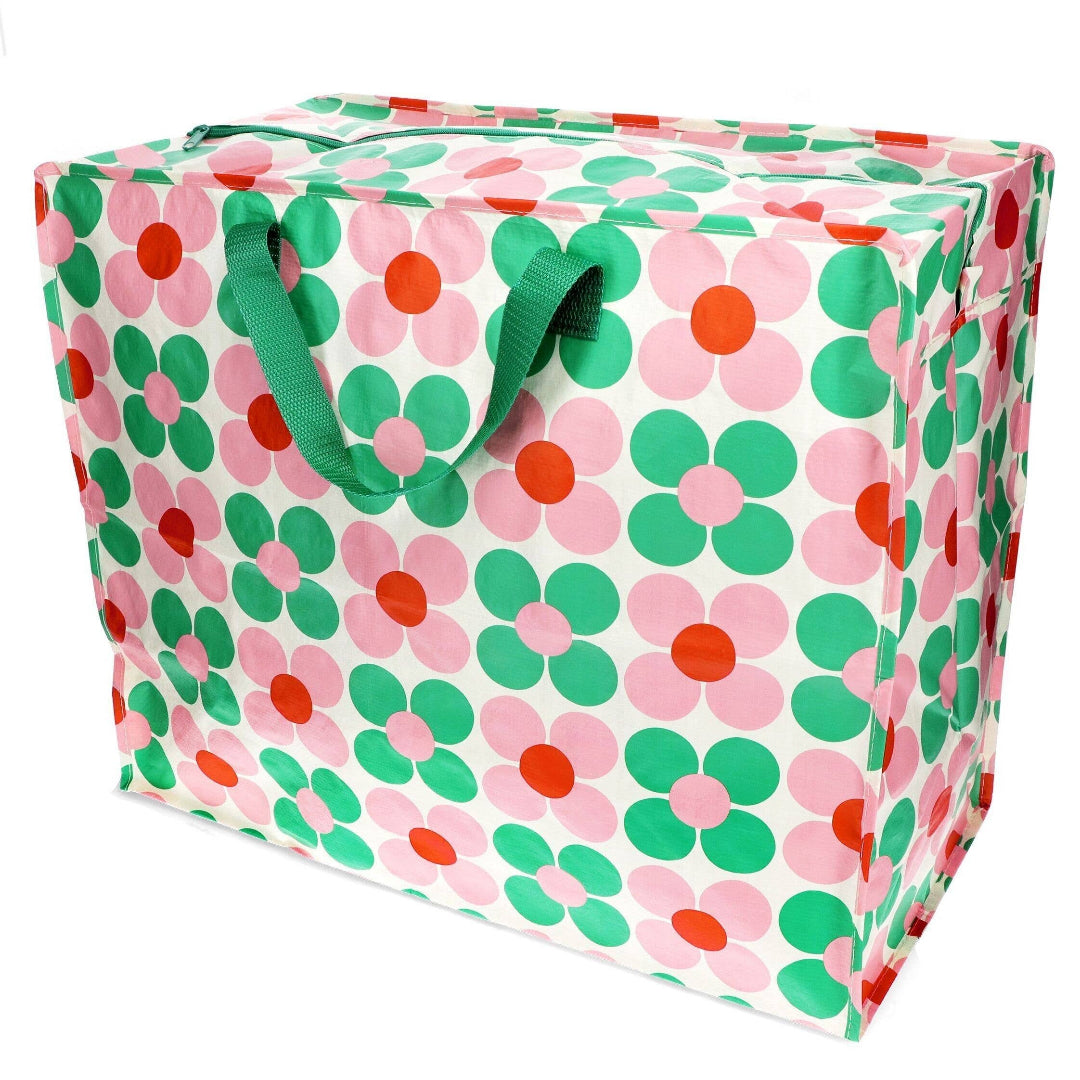 Floral-patterned storage bag with green handles on a white background