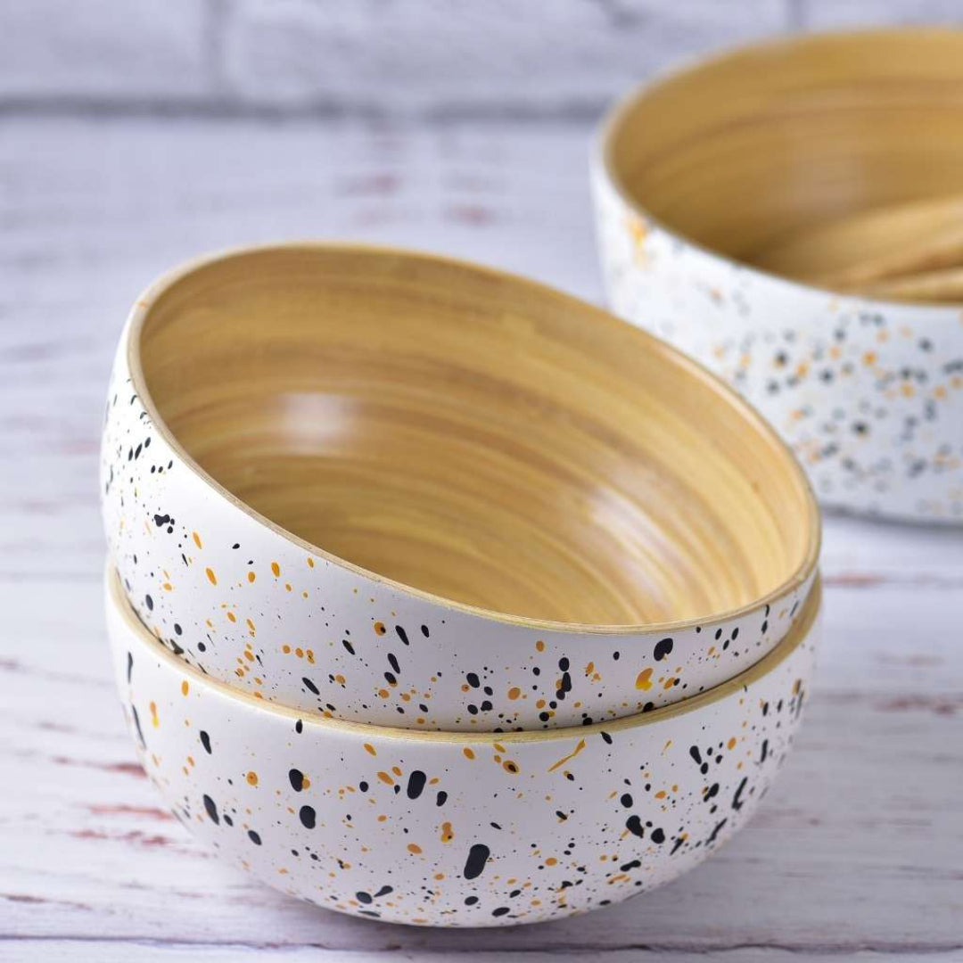 Two ceramic bowls with speckled patterns on a wooden surface