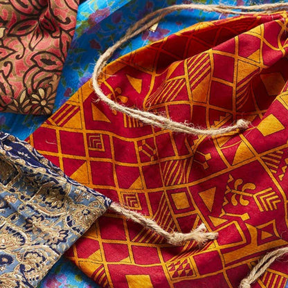 layers of colourful gift bags made from recycled saris with hessian draw strings