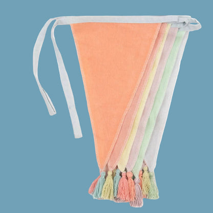 Colorful pastel bunting with tassels on a blue background