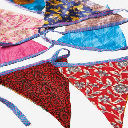 String of fabric recycled sari bunting. Assorted bright colours and designs.
