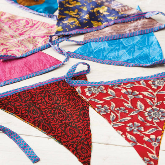 String of fabric recycled sari bunting. Assorted bright colours and designs.