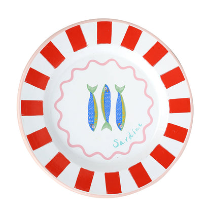 Round plate with red and white striped border and fish illustration on a white background