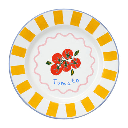 Decorative plate with tomato design and yellow stripes on a white background