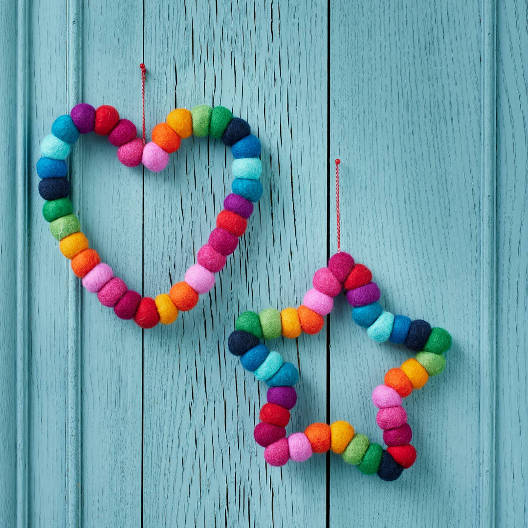 Colorful heart and star-shaped decorations made of multicolored pompoms 
