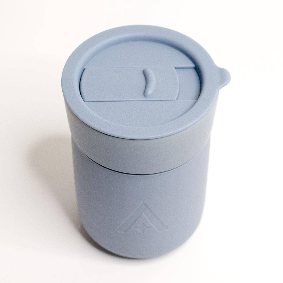 Light blue tumbler with a lid on a white background