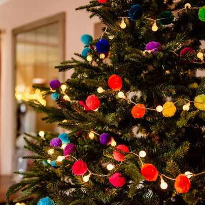 christmas tree decorated with rainbow pompom fairy light chain