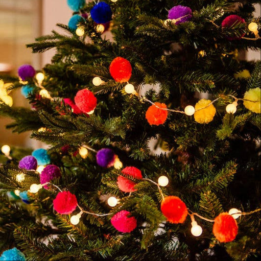 christmas tree decorated with rainbow pompom fairy light chain