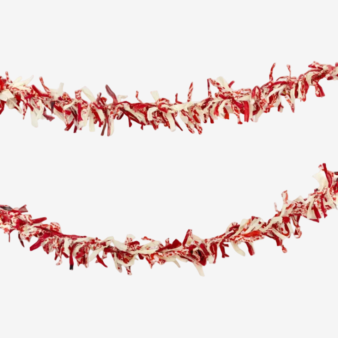 Red and white tinsel garland on a white background
