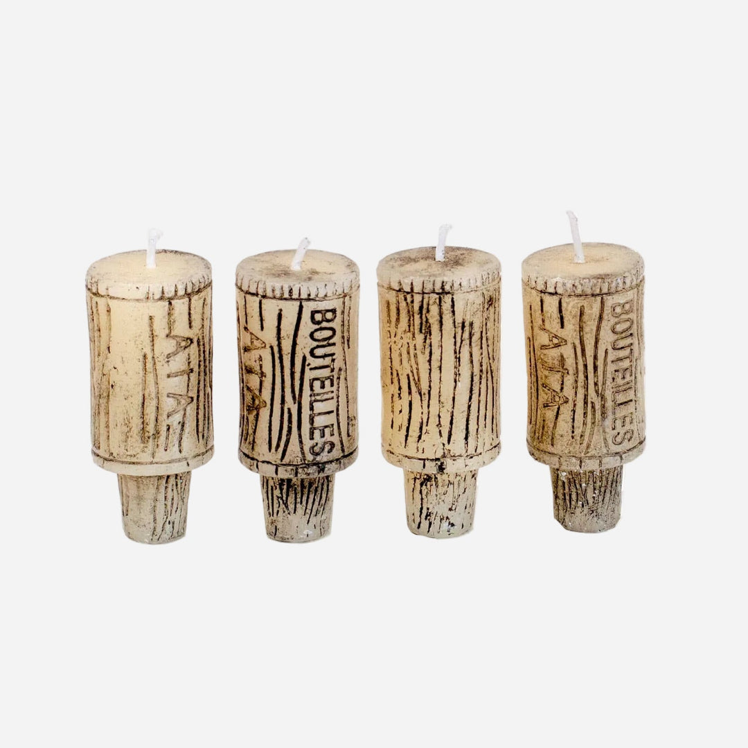 Four wine cork candles with 'Bouteilles' text on a white background