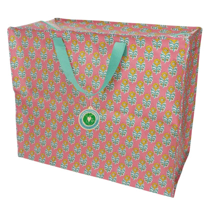 Salmon pink jumbo storage bag with floral pattern and light green handles on a white background