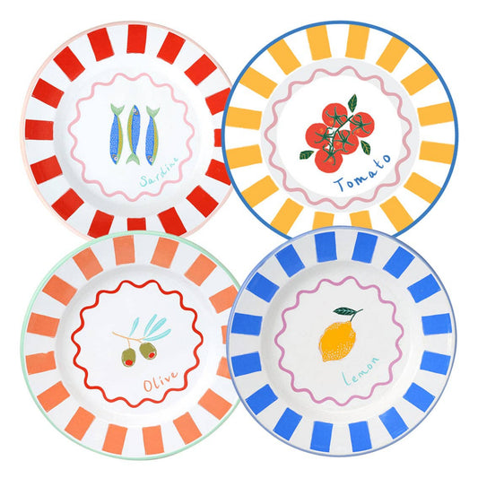 Set of four decorative enamel plates with fruit and vegetable designs on a white background