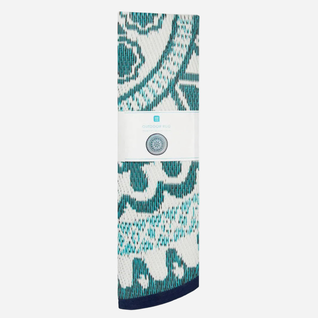 folded rug with blue and white patterned design on a white background