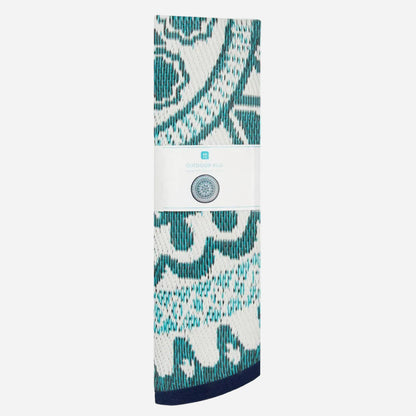 folded rug with blue and white patterned design on a white background