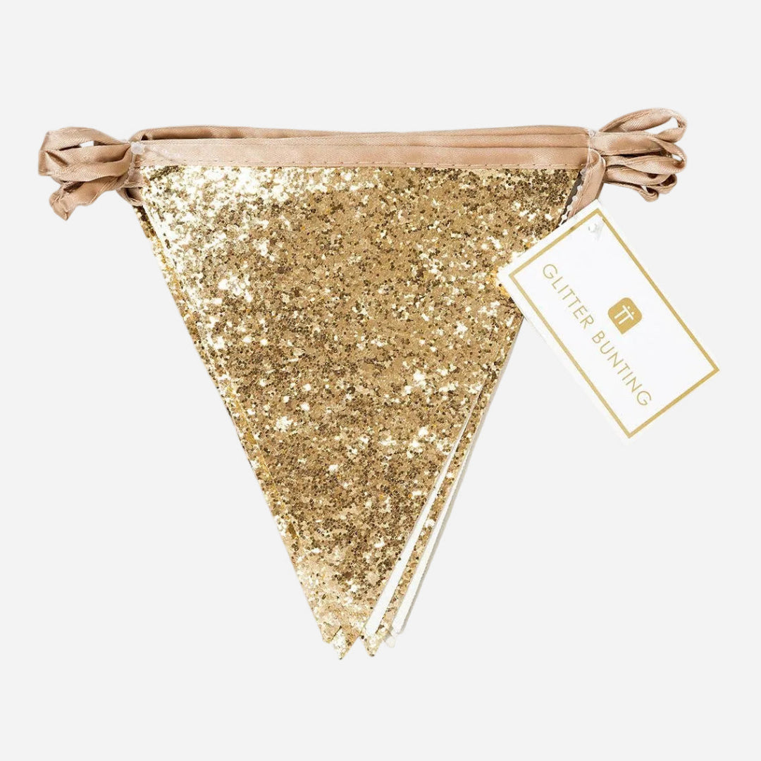 Gold glitter bunting with packaging on a light grey background