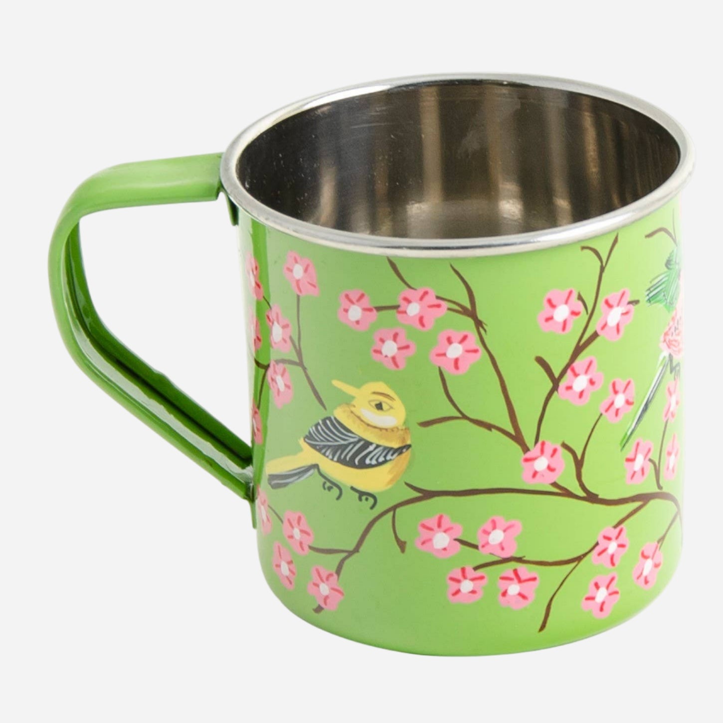 Green mug with floral design and bird illustration on a light grey background