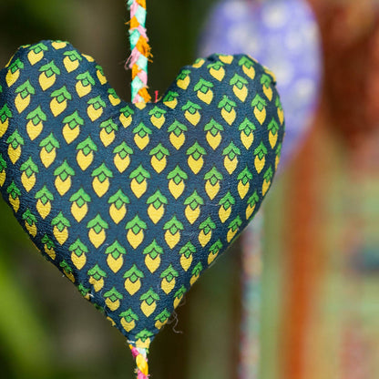 Single heart from decorative heart string. This heart is navy with yellow/green lemon-like print.