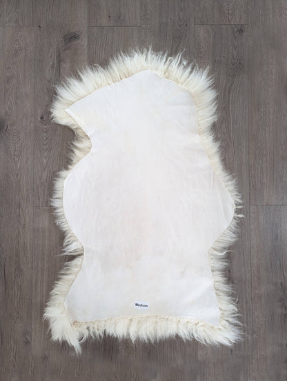 underside of a natural sheepskin on a wooden floor