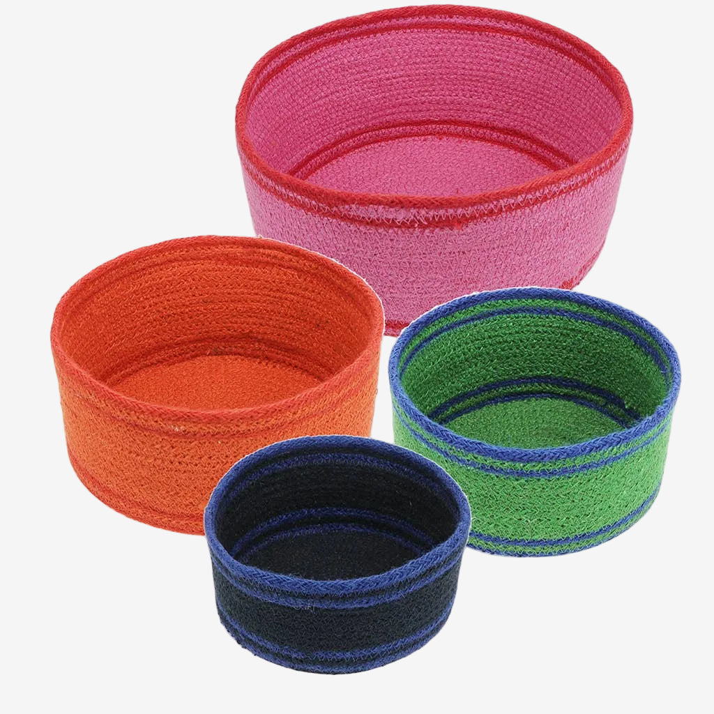 Set of colorful woven storage baskets in pink, orange, blue, and green on a white background