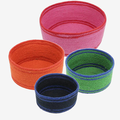Set of colorful woven storage baskets in pink, orange, blue, and green on a white background