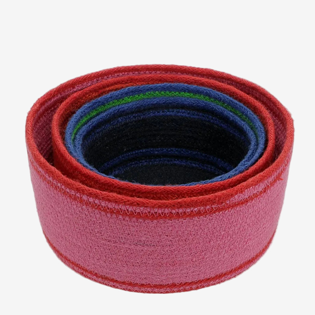 Set of 4 red and blue woven nesting storage  baskets stacked on a white background.