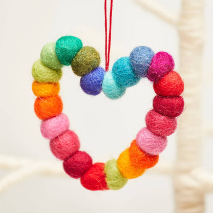 Colourful felt heart ornament hanging on a branch