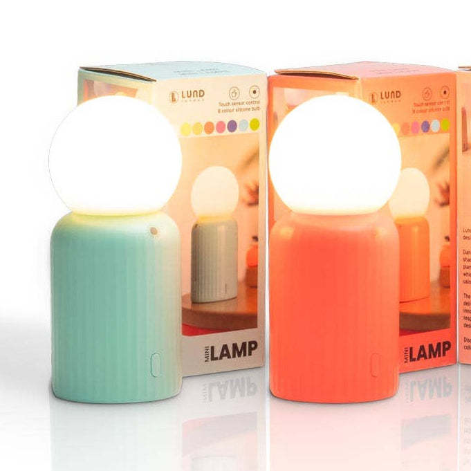 Two colorful wireless mini lamps with packaging on a white background
