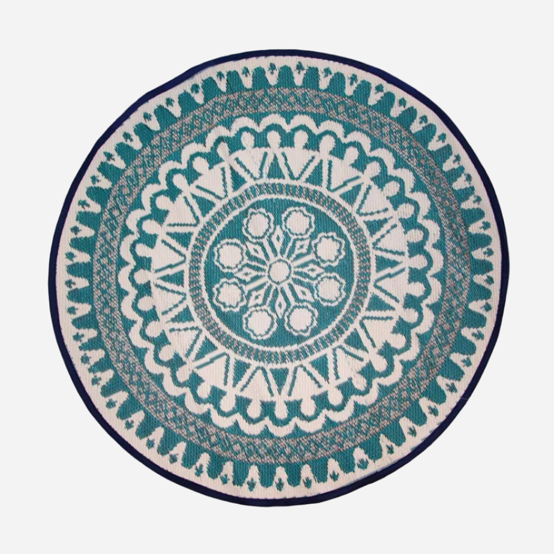 Round rug with a blue and white geometric pattern on a white background
