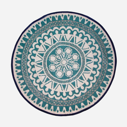 Round rug with a blue and white geometric pattern on a white background