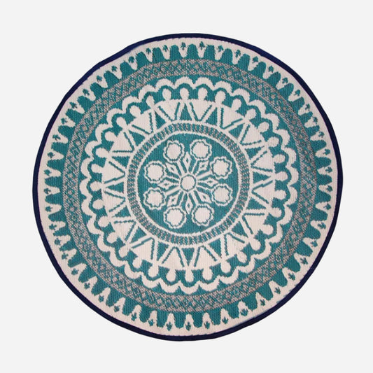 Round rug with a blue and white geometric pattern on a white background