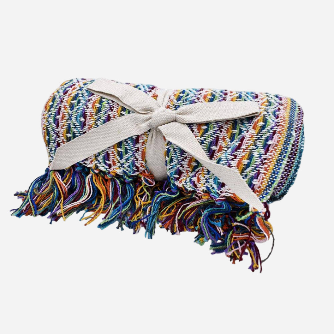 Multicolored woven blanket with tassels on a white background