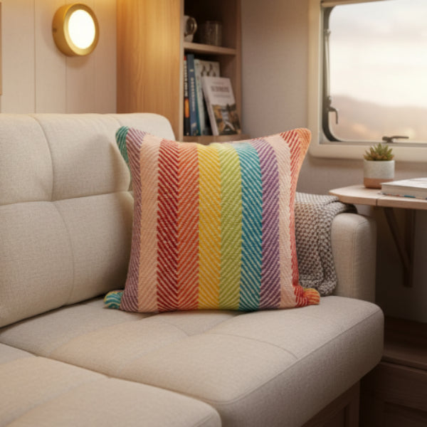 Colorful striped cushion cover with a zigzag pattern on a caravan sofa