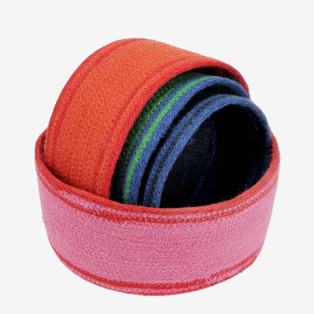 Set of colorful woven jute storage baskeds in orange, pink, blue and green