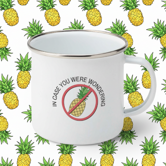 white enamel camping mug with text "in case you were wondering" plus image of a pineapple in a red circle with a red line through.