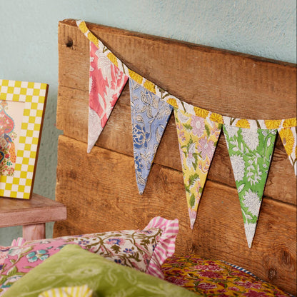 Decorative headboard with colorful fabric bunting