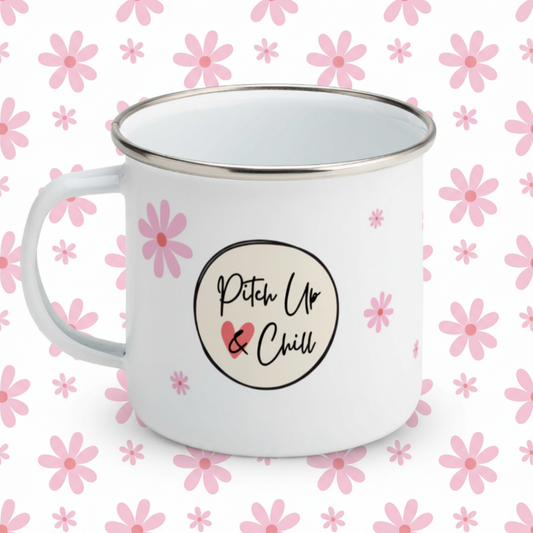 white enamel mug with Pitch Up and Chill logo and pink daisy flowers of varying sizes against a pink daisy background.
