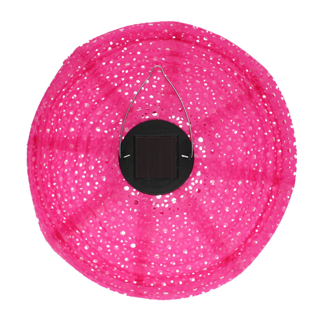 Pink solar lantern seen from above with a visible solar cell, on a grey/blue background