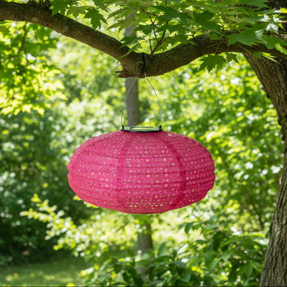 Pink solar lantern hanging from a tree