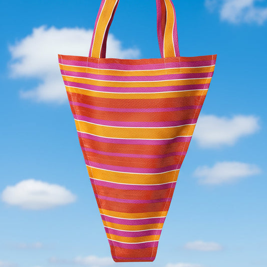 bright pink and orange striped tote bag on a blue background (contains bunting of same material)