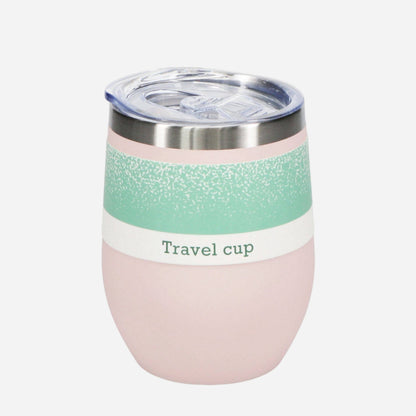Pink travel cup with a green band label and clear lid on a white background