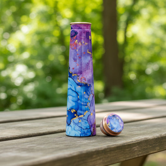 Marbled purple and blue water bottle with rose gold accents on a white background