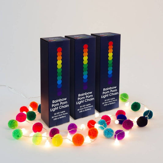 three tall boxes surrounded by pompom fairy light chain