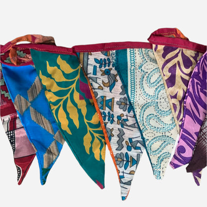 string of recycled sari bunting in various coloured and patterned fabrics